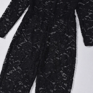 Detailed view of the intricate floral lace patterns on long sleeve black bodysuit