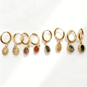 Flat lay of vintage oval zircon drop earrings in eight colorful gemstone options