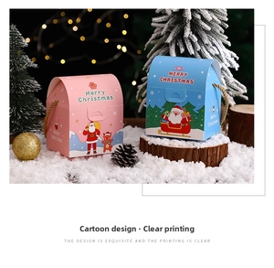 Detail of Christmas gift boxes with Santa patterns and golden woven handles