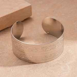 Detail of silver wide open cuff bracelet with vintage geometric relief patterns