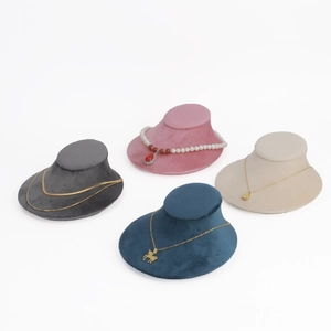 Macro view of velvet necklace bust display stands in four elegant colors for jewelry shops