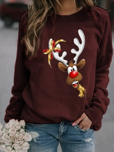 Detailed close-up of Christmas deer print with bow and bell on burgundy sweatshirt