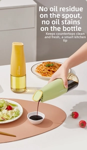 Detail of automatic gravity lid oil dispenser bottle pouring soy sauce in kitchen