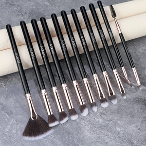 Detailed view of 12-piece black and rose gold makeup brushes with synthetic bristles