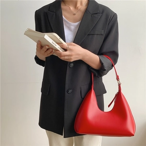 Chic red PU leather crescent shoulder bag styled with a professional black blazer