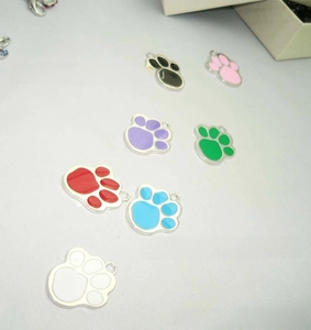 Detailed close-up of six colorful metal cat paw charms for pet ID tags and DIY jewelry