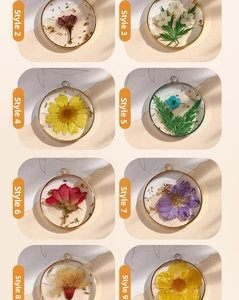 Detail of handmade resin flower pendants with gold foil in varied floral styles