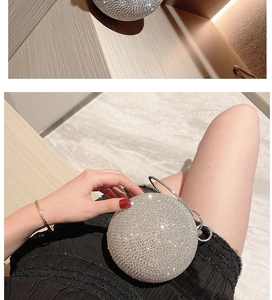 Sparkling silver spherical evening bag with rhinestones and metal ring handle held by a model