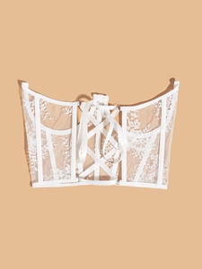 Detailed back view of white lace corset featuring criss-cross lacing and metal eyelets