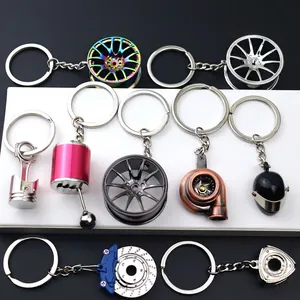 Creative metal car part keychains featuring turbo, wheel hub, and brake disc designs