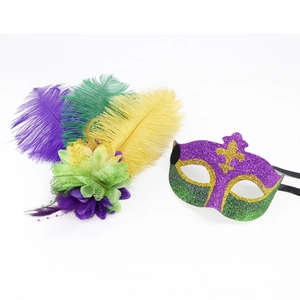 Detail of Mardi Gras party set with purple green and gold glitter mask and feather headpiece