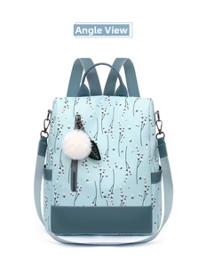 Detail of floral Oxford backpack with navy faux leather trim and white pompom charm