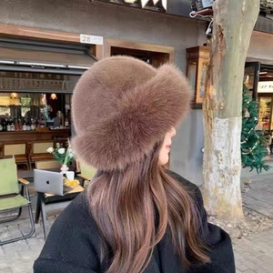 Plush faux fur bucket hat in dark brown, thick winter fisherman cap for women in outdoor setting