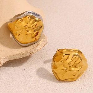 Detailed view of snake head rings with irregular lava texture in gold and silver finish