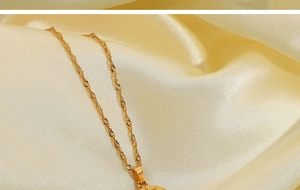 Detail of gold water wave chain with a vintage round portrait relief pendant