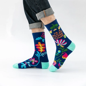 Artistic navy floral crew socks featuring bold quote and colorful mint green patchwork