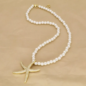 Elegant beaded pearl necklace with starfish and conch pendants on golden satin