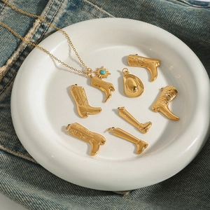 Golden titanium steel necklace with sun and turquoise charms on blue denim