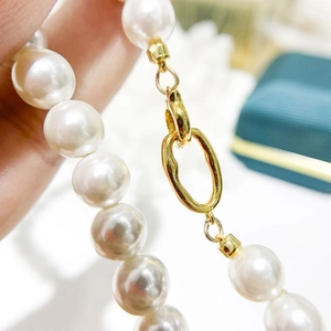 Elegant white pearl necklace with a polished S925 sterling silver gold clasp mechanism