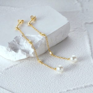 Detail of S925 sterling silver tassel earrings with delicate pearls and sparkling diamonds