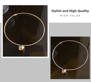 Detail of minimalist gold-plated choker with sleek snake chain and polished ball pendant