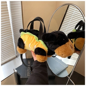 Detail view of a cute plush dog taco bag with a black handle and detachable shoulder strap