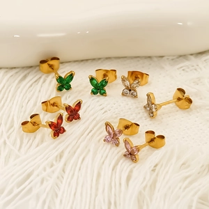 Elegant gold butterfly earrings with colorful cubic zirconia crystals on white fabric