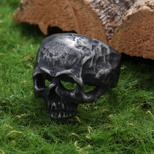 Vintage gothic skull ring for men in antique silver finish on natural grass background