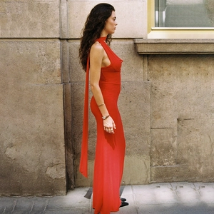 Detailed view of the back of a red backless dress featuring long elegant flowing ribbons
