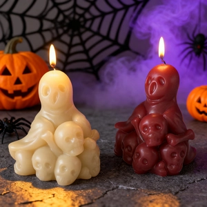 Ghost and skull scented candles in cream and red colors for Halloween decor setup