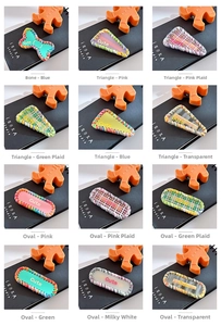 Detail of 12 cute geometric hair clips with colorful woven edges and cute text