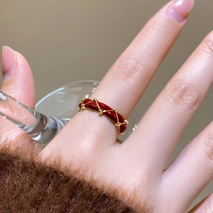 Detail of red enamel and 24K gold plated ring featuring diagonal woven texture