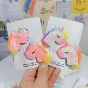 Detail of glittery unicorn hair clips with rainbow plush and soft mesh for young girls