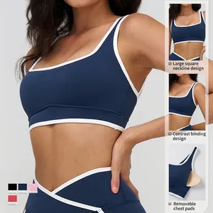 Dark blue square neck yoga bra with white contrast piping and professional V-cut waist hem