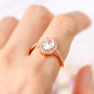 Elegante anello di fidanzamento in oro rosa con grande zircone ovale sulla mano