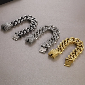 Detailed close-up of heavy stainless steel bracelets in black, silver and gold finishes
