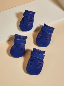 Close-up of four navy blue breathable mesh dog shoes with adjustable velcro straps