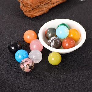 Polished 20mm natural crystal spheres in various gemstones displayed in a ceramic bowl