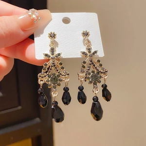 Detail of vintage black tassel earrings with 925 silver needles and dark crystals