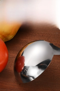 Close-up of mirror-polished stainless steel soup ladle with smooth reflective finish