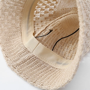Detail of breathable knit bucket hat showing interior sweatband and adjustable string