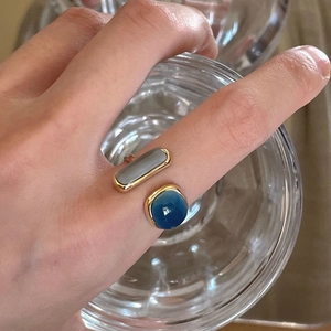 Minimalist gold adjustable ring with emerald cut grey stone and round blue gem