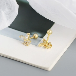 Close-up of gold butterfly stud earrings with sparkling crystals and screw back