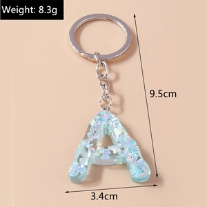 Detailed view of capital letter A keychain with blue sequins and silver metal ring
