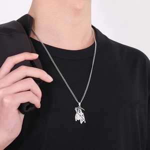 Silver grim reaper scythe necklace shown on male model wearing black clothes
