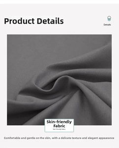 Close-up of soft dark grey washed cotton fabric with fine texture and natural folds