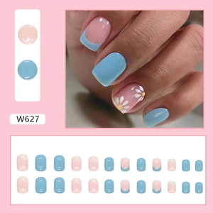 Detail view of 24pcs blue and pink press-on nails with white daisy floral designs