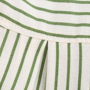 Vue macro du tissu à rayures blanches et vertes avec coutures renforcées et texture en lin