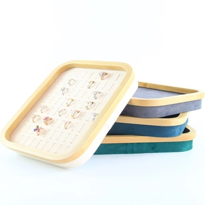 Detailed macro view of the bamboo wood ring display tray with premium green microfiber slots