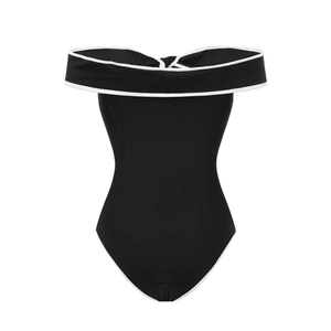 Detailed view of black one-shoulder swimsuit with elegant white piping and bow accents